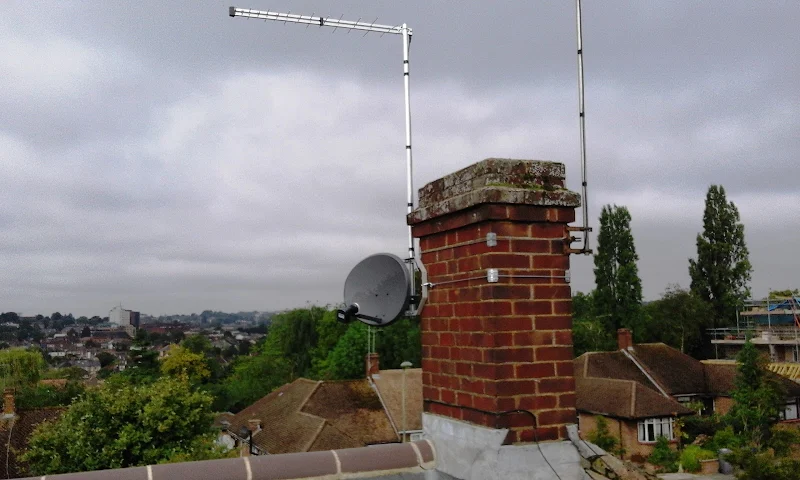 Satellite dish and TV aerial mounted on chimney