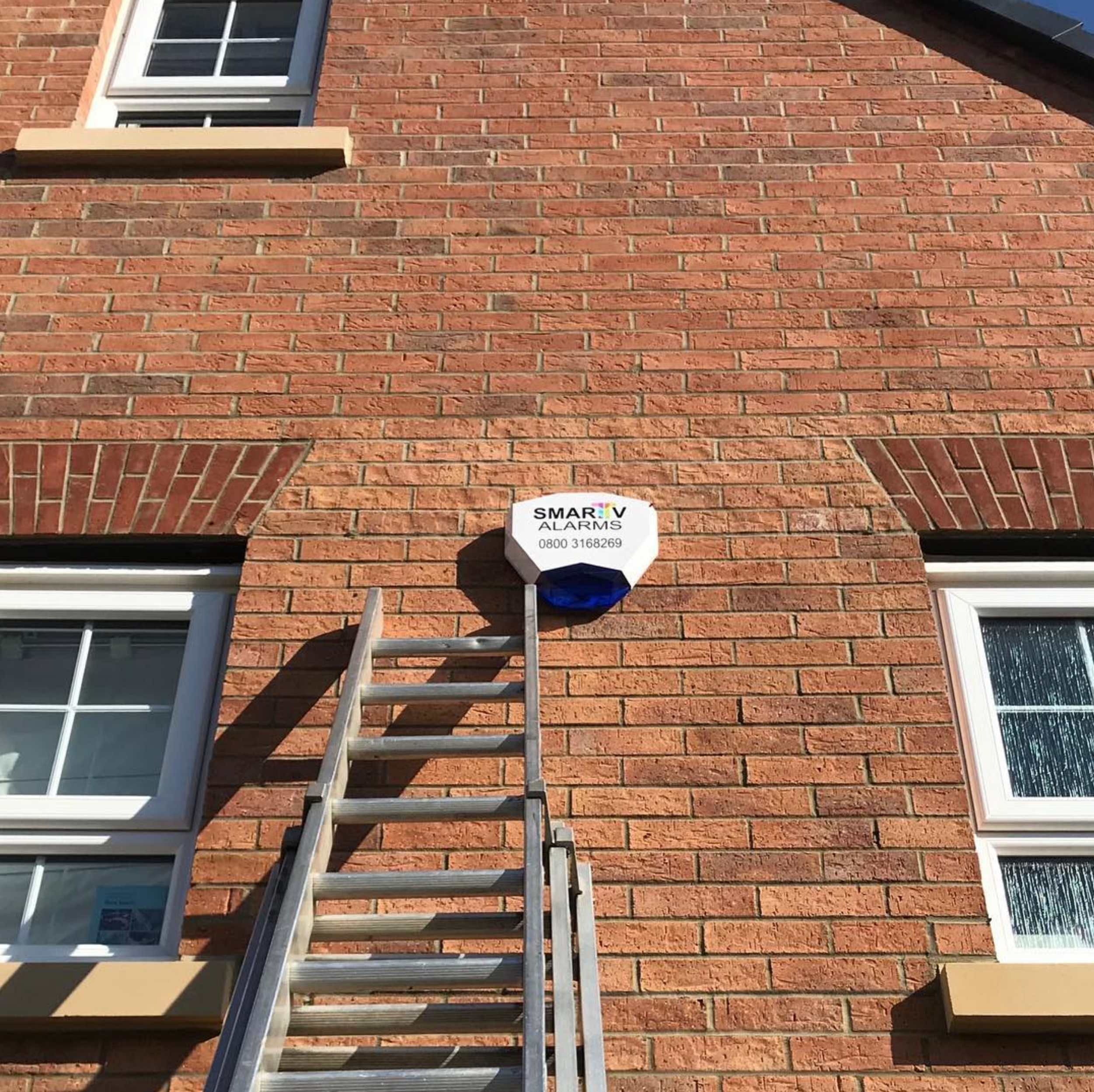 Smart house alarm box on brick wall