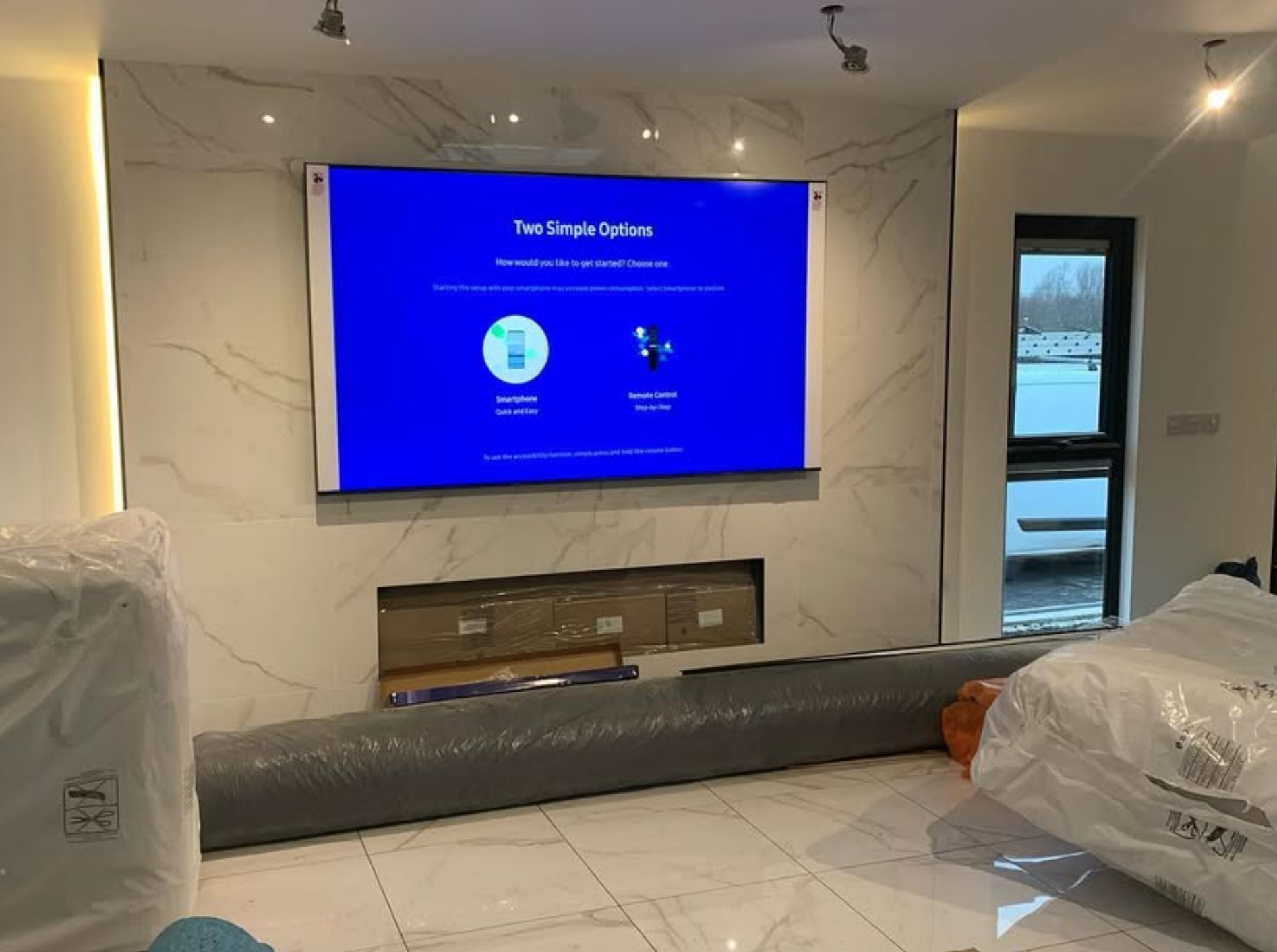 100-inch TV wall mounted on luxury marble feature wall